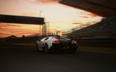 A powerful sports car racing on a track at sunset, highlighting speed and elegance.